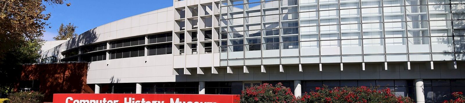 A modern building with a red sign reading “Computer History Museum” under a clear blue sky.